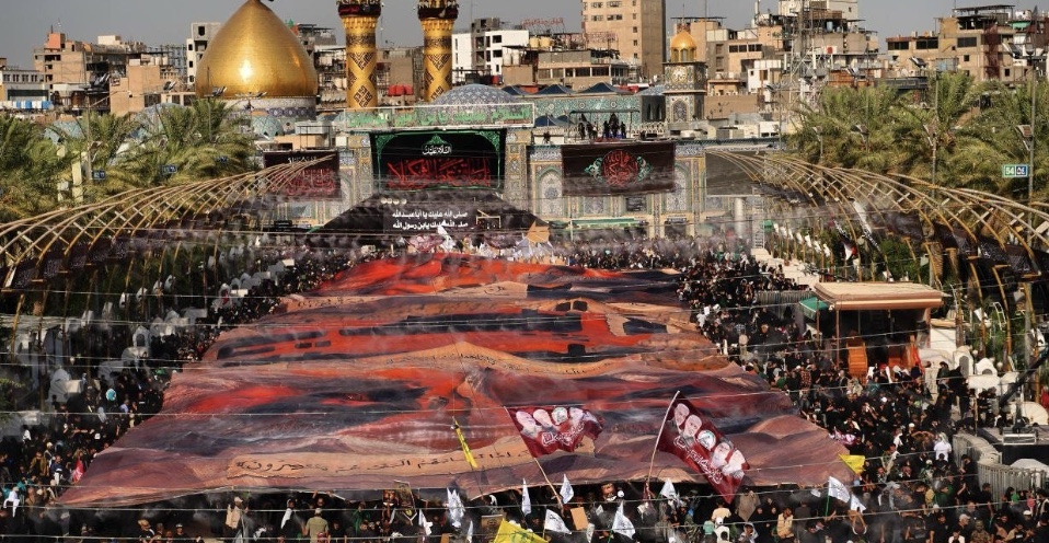 الحشد الشعبي: رفع أكبر لوحة لتوثيق صور الشهداء بين الحرمين الشريفين